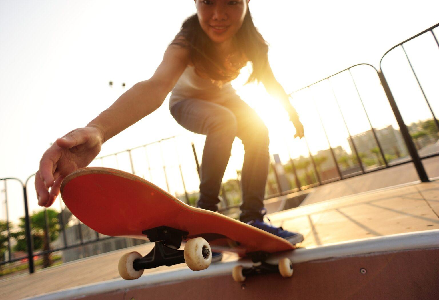 Skateboarder skateboarding at sunrise skatepark