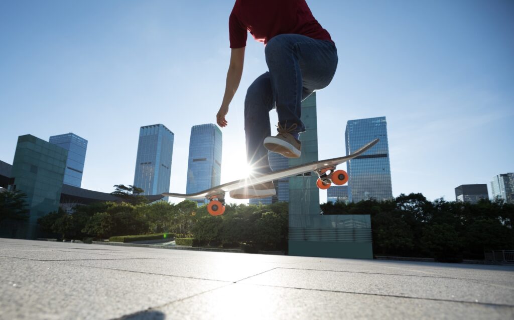 Asian woman skateboarder skateboarding in modern city