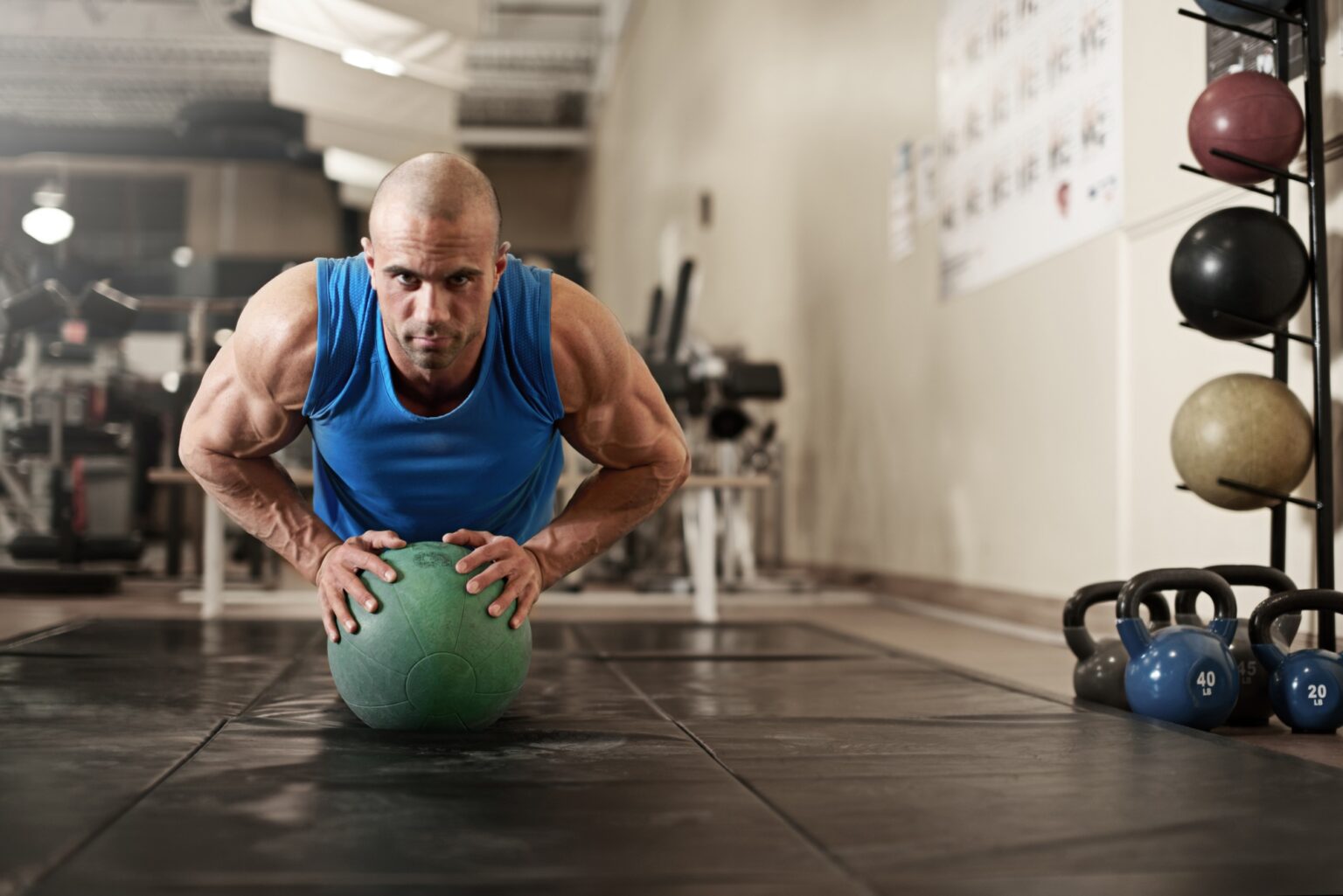 bodybuilder working out and doing push upsat the gym while