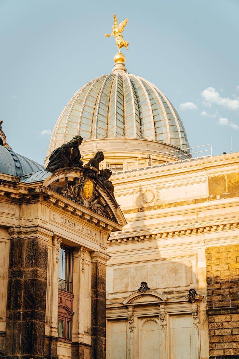 View of the dome at Dresden's Academy of Fine Arts bathed in warm sunlight.